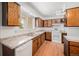 Functional kitchen featuring classic wood cabinets, laminate countertops, and modern lighting at 6413 W 76Th Ave, Arvada, CO 80003