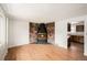 Bright living room featuring hardwood floors and a unique stone fireplace at 6413 W 76Th Ave, Arvada, CO 80003