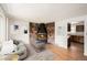 Inviting living room with a striking stone fireplace, hardwood floors, and abundant natural light at 6413 W 76Th Ave, Arvada, CO 80003