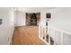 Spacious living room with hardwood floors, a stone fireplace, and staircase at 6413 W 76Th Ave, Arvada, CO 80003