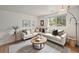 Cozy living room with a comfortable sectional sofa, neutral decor, and natural light at 6413 W 76Th Ave, Arvada, CO 80003