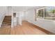 Bright living room featuring hardwood floors and a large window at 6413 W 76Th Ave, Arvada, CO 80003