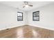 Spacious bedroom showcases wood floors, natural light from windows, and a ceiling fan at 1591 Holly St, Denver, CO 80220