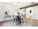 Modern dining room with stylish light fixture, hardwood floors, and elegant decor at 1591 Holly St, Denver, CO 80220