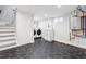 Finished basement laundry room with modern appliances, a utility sink, and decorative black hexagon tile floor at 1591 Holly St, Denver, CO 80220