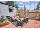 Back patio with comfortable seating arrangement, including a sofa, chairs, and an umbrella at 1591 Holly St, Denver, CO 80220