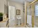 Bathroom features a pedestal sink, gold-framed shower, and storage at 1256 S Pennsylvania St, Denver, CO 80210