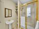 Bathroom showcases a gold-framed glass shower, pedestal sink, and storage shelves at 1256 S Pennsylvania St, Denver, CO 80210