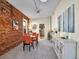 Bright dining area with exposed brick, a modern table set, and stylish decor at 1256 S Pennsylvania St, Denver, CO 80210