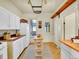 Cozy kitchen with white cabinets, butcher block countertops, and a kitchen island at 1256 S Pennsylvania St, Denver, CO 80210