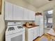 Bright kitchen with white cabinets, gas range stove, a window, and butcherblock countertops at 1256 S Pennsylvania St, Denver, CO 80210