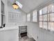 Bright laundry room with storage shelves and white appliances at 1256 S Pennsylvania St, Denver, CO 80210