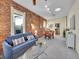 Inviting living room with exposed brick, stylish furniture, and abundant natural light at 1256 S Pennsylvania St, Denver, CO 80210