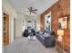 Comfortable living room with exposed brick, ceiling fan, and ample natural light at 1256 S Pennsylvania St, Denver, CO 80210