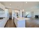 Modern kitchen with white cabinets, island, and stainless steel appliances at 13840 Deertrack Ln, Parker, CO 80134