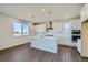 Modern kitchen with white cabinets and island at 13840 Deertrack Ln, Parker, CO 80134