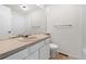 Functional bathroom featuring a large mirror, single sink vanity, and a standard toilet at 14099 E Radcliff Cir, Aurora, CO 80015