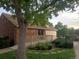 Brick home exterior featuring a ramp to the entrance, complemented by lush landscaping at 14099 E Radcliff Cir, Aurora, CO 80015