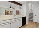 Bright kitchen area with a view to the staircase and wood floors at 14099 E Radcliff Cir, Aurora, CO 80015