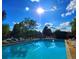 Inviting outdoor pool surrounded by lounge chairs and lush greenery under a sunny sky at 14099 E Radcliff Cir, Aurora, CO 80015