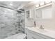 Bathroom with tiled shower, glass door, and modern vanity with a mirror at 5385 W 51St Ave, Denver, CO 80212