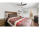 Comfortable bedroom featuring a ceiling fan, wood floors, and an en-suite bathroom at 5385 W 51St Ave, Denver, CO 80212