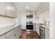 Modern kitchen with gray cabinets, granite countertops, stainless steel appliances, and hardwood floors at 5385 W 51St Ave, Denver, CO 80212