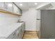 Basement kitchen with white cabinets, ample counter space, and stainless steel refrigerator at 5385 W 51St Ave, Denver, CO 80212
