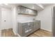Finished basement featuring a kitchenette with gray cabinets, stylish countertop, and ample storage at 5385 W 51St Ave, Denver, CO 80212