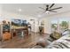Inviting living room with hardwood floors, fireplace, entertainment center, and sliding glass doors at 5385 W 51St Ave, Denver, CO 80212