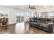 Spacious living room with hardwood floors, view of the kitchen, and access to a balcony at 5385 W 51St Ave, Denver, CO 80212