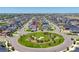 An aerial view showcasing the location of the house and a community green space with a roundabout at 9716 Uravan St, Commerce City, CO 80022
