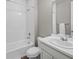 Clean bathroom with white subway tile surround, shower, toilet, and vanity at 9716 Uravan St, Commerce City, CO 80022