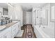 Bright bathroom features double vanities, a soaking tub and separate shower at 9716 Uravan St, Commerce City, CO 80022