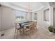 Dining room featuring tray ceiling, natural light, a modern chandelier and neutral color palette at 9716 Uravan St, Commerce City, CO 80022