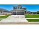 Two-story home featuring a three-car garage, landscaped yard, and a well-maintained lawn at 9716 Uravan St, Commerce City, CO 80022