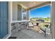Charming covered front porch with stone accents, seating, and a view of the neighborhood at 9716 Uravan St, Commerce City, CO 80022