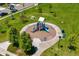 An aerial view of a playground featuring a play structure with a slide and green surroundings at 9716 Uravan St, Commerce City, CO 80022