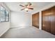 Neutral bedroom with a ceiling fan, window, carpet, and a pair of closet doors at 8090 Kline Ct, Arvada, CO 80005