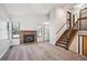 Spacious living room featuring a brick fireplace, staircase, and ample natural light at 8090 Kline Ct, Arvada, CO 80005