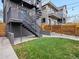 A modern-style residence features a nice green backyard and metal stairs with wooden fence at 3538 Pecos St, Denver, CO 80211