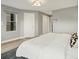 Bedroom featuring a large bed, light gray walls, and natural light from the window at 3538 Pecos St, Denver, CO 80211
