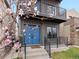 Close-up of home's entry with blue doors, modern railings, blooming tree, and address number at 3538 Pecos St, Denver, CO 80211