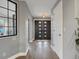 Foyer with hardwood floors, gray walls, a dark front door, and white interior door at 3538 Pecos St, Denver, CO 80211