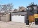 A detached garage is featured with a white door and modern metal siding at 3538 Pecos St, Denver, CO 80211