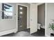 Light and airy hallway with modern decor, gray slate floors and a partial bathroom at 3538 Pecos St, Denver, CO 80211