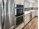 Stainless steel appliances, light wood cabinets, and hardwood floors adorn this modern kitchen at 3538 Pecos St, Denver, CO 80211