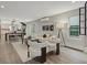 Open-concept living space featuring hardwood floors, white furniture, and an attached dining area and kitchen at 3538 Pecos St, Denver, CO 80211