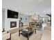Open-concept living room with fireplace, TV, and adjacent dining area and modern kitchen at 3538 Pecos St, Denver, CO 80211