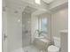 Shower featuring stylish tile work, glass enclosure, and a built-in bench at 3538 Pecos St, Denver, CO 80211
